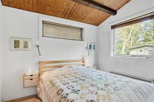 a bedroom with a bed and a large window at 10054-Rorvig-Lindegardsvaenget-27 in Rørvig