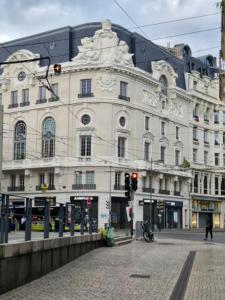 a large white building on the corner of a street at Tréfilerie in Saint-Étienne