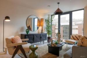 a living room with a mirror and a couch at Apex Executive Apartments - The Ironworks in Dublin