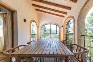 a wooden table in a room with windows at Javea Vedat by Concept Flats in Jávea