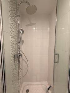 a bathroom with a shower with a glass door at Studio Vigie 212 vue mer, accès piscine in Le Diamant