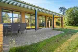 a patio with a table and chairs in front of a house at LF229-Vestervig-Hannesvej-16 in Vestervig