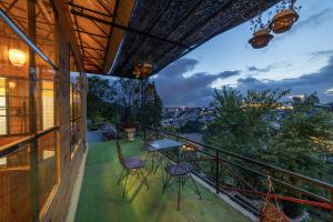 a balcony of a house with a table and chairs at Sunset Valley Dalat in Khu Chi Lăng