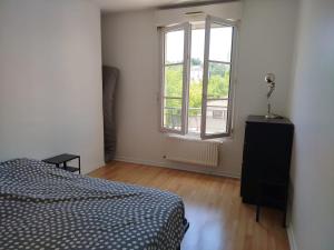 a bedroom with a bed and a window at Tréfilerie in Saint-Étienne