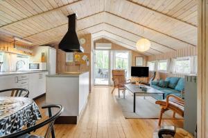 a kitchen and living room with a couch and a table at 0008-Romo-Froidal-24 in Høm