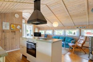 a kitchen and living room with a stove top oven at 0008-Romo-Froidal-24 in Høm +27 photos