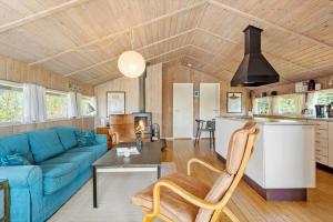 a living room with a blue couch and a table at 0008-Romo-Froidal-24 in Høm