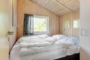 a large bed in a room with a window at 0008-Romo-Froidal-24 in Høm