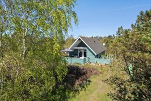 a green house in the middle of the forest at 0008-Romo-Froidal-24 in Høm