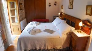 a bedroom with a bed with a laptop on it at Casa Piñeiro in Monfero +282 photos