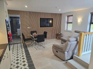a living room with a couch and a chair at Dunderry Lodge Luxury Suites in Navan
