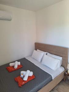 a bed with towels and pillows on top of it at Villa Marcella by the Sea in Kamisianá