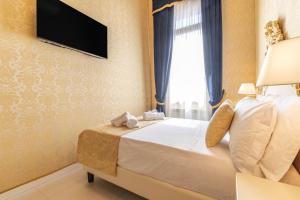 a bedroom with a bed with a television on the wall at Rialto Charm Boutique in Venice +53 photos