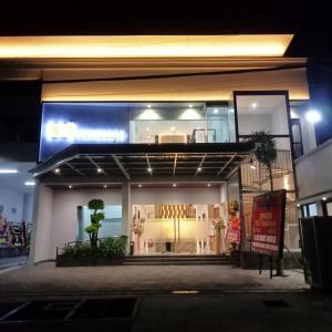 a store front of a building at night at NH Residence Yogyakarta in Ngabean