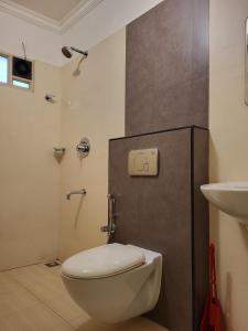 a bathroom with a toilet and a sink at Hotel Grand Vista in Cochin