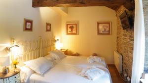 a bedroom with a white bed with towels on it at Casa Piñeiro in Monfero