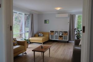 a living room with two couches and a table at The Blue Wren in Blackheath