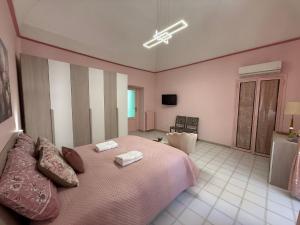 a bedroom with a large bed with two towels on it at Domus Lucrezia in Bisceglie +6 photos