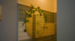 a yellow mirror on a wall with a plant at The Cloud9 Villa in Tezpur +16 photos