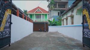 a gate to a building with a motorcycle parked in front at The Cloud9 Villa in Tezpur