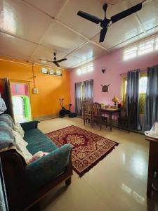 a living room with a couch and a table at The Cloud9 Villa in Tezpur