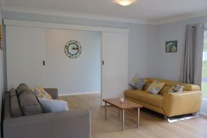 a living room with a couch and a table at The Blue Wren in Blackheath +30 photos