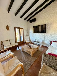 a living room with couches and a flat screen tv at Maison avec vue mer à Propriano in Propriano