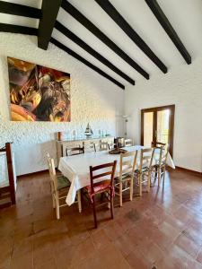 a dining room with a white table and chairs at Maison avec vue mer à Propriano in Propriano