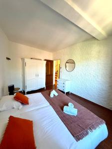 a bedroom with a large white bed with towels on it at Maison avec vue mer à Propriano in Propriano +15 photos