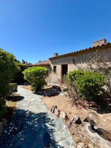 a stone path leading to a house with a building at Maison avec vue mer à Propriano in Propriano