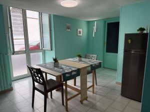 a kitchen with a table and a refrigerator at Domus Lucrezia in Bisceglie