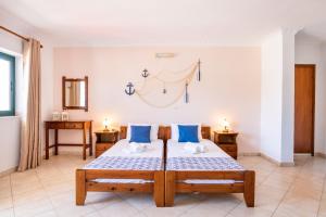 a bedroom with a bed with blue pillows at Giota's Studio in Karpathos