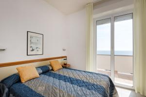 a bedroom with a bed and a large window at Hotel Man in Lido di Savio +115 photos