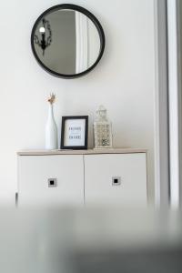 a white dresser with a mirror on top of it at Rodostagma 1 in Rodholívos