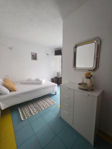 a bedroom with a bed and a mirror on the floor at Pensiunea Mallorca Restaurant - Bar in Vişeu de Sus