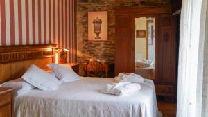 a bedroom with two beds with towels on them at Casa Piñeiro in Monfero