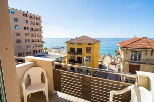 a balcony with a view of the ocean and buildings at Hotel Corallo in Pietra Ligure