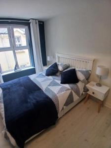 a bedroom with a bed and a window at Seafront Apartment in Newcastle