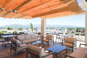 a patio with tables and chairs and a view at Cervino in Ulcinj