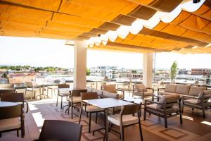 a patio at a restaurant with tables and chairs at Cervino in Ulcinj