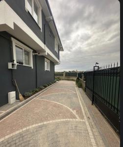 a house with a fence and a brick driveway at İkizler villa in Edirne
