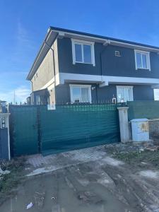 a house with a green fence in front of it at İkizler villa in Edirne