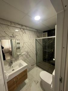 a bathroom with a sink and a toilet and a shower at İkizler villa in Edirne