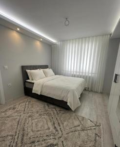 a bedroom with a large bed and a rug at İkizler villa in Edirne