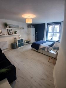 a bedroom with a bed and a large window at Seafront Apartment in Newcastle