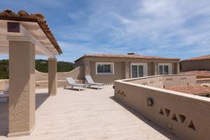 a patio with two chairs and a house at Hotel Nibaru in Porto Cervo