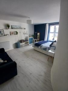 a bedroom with a bed and a large window at Seafront Apartment in Newcastle +6 photos