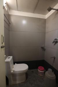 a bathroom with a white toilet in a room at Hotel BCP Suites in Bangalore +54 photos