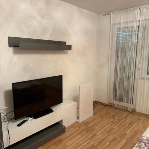 a living room with a flat screen tv on a white cabinet at Villa BESA - BA Debar in Debar