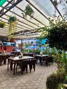 a restaurant with tables and chairs in a building at Bhandari hotel and sekuwa corner in Pashupatināth